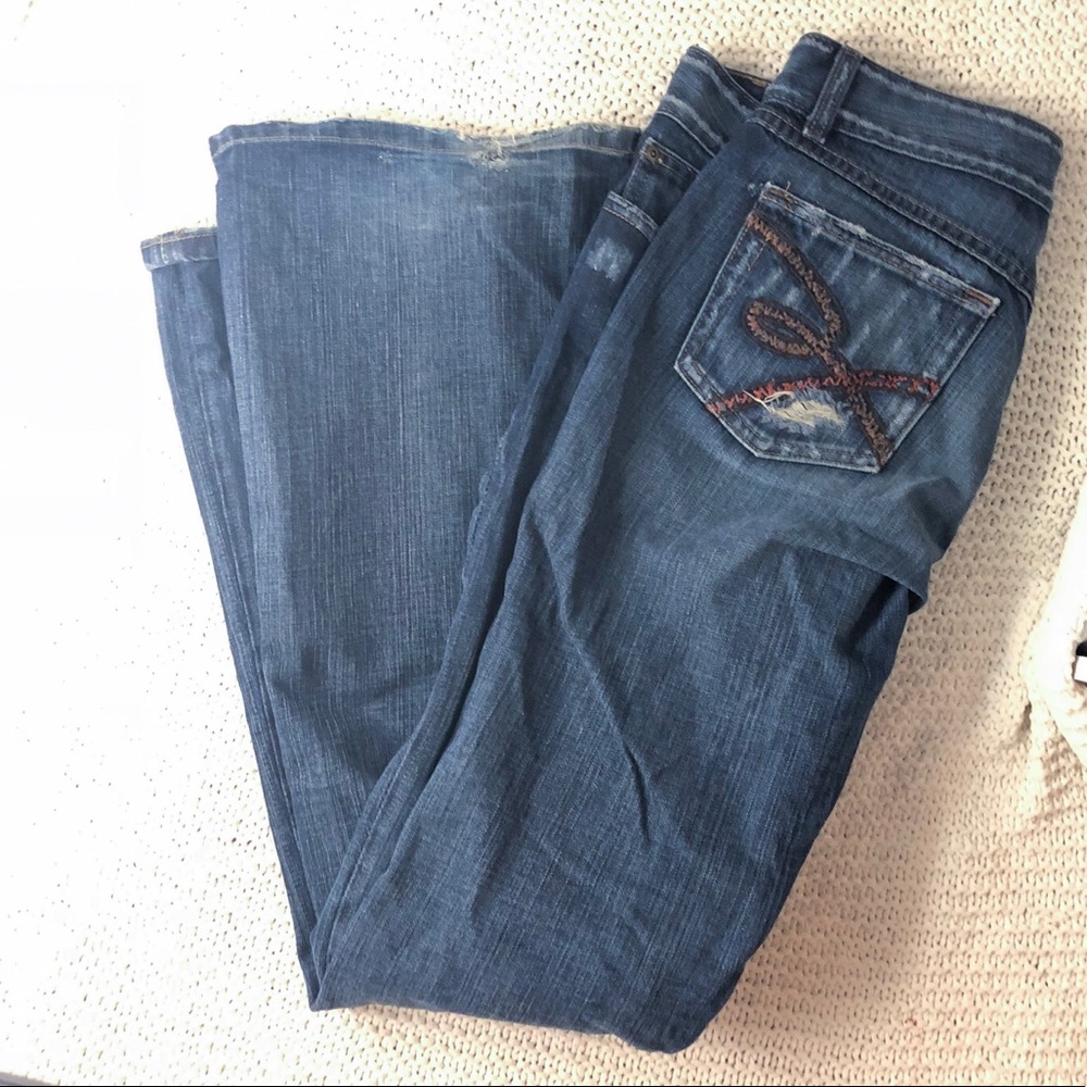 Long dark buckle jean with flare leg